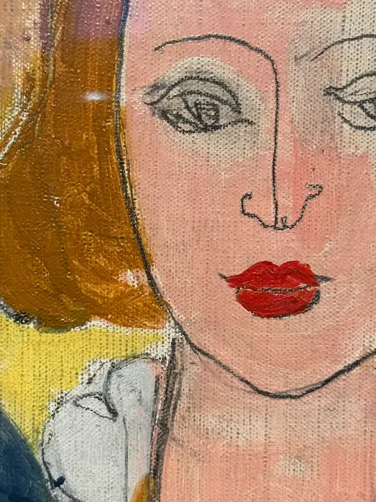 A face painted in a few lines, red lips, ochre hair
